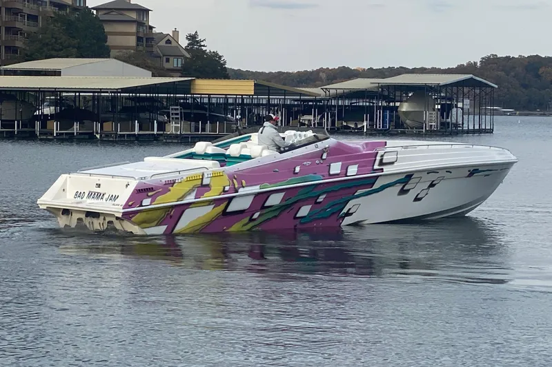 Slide: The Image of Colorful 1999 Black Thunder XT 430 SC speedboat on a lake near docks. - 53