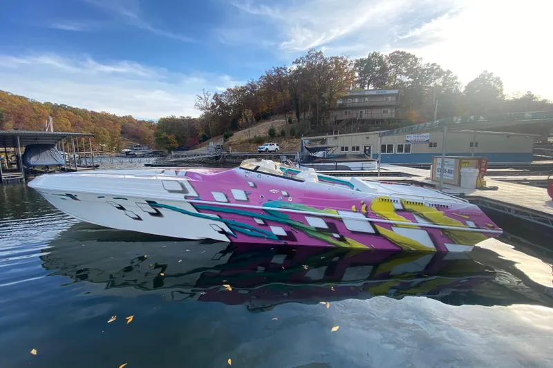 Slide: The Image of Colorful 1999 Black Thunder XT 430 SC speedboat docked on a serene lake. - 7