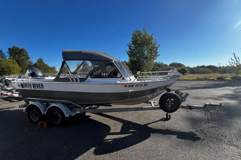 Slide: The Image of 2008 North River 18 SEA HAWK boat on trailer, parked outdoors under clear sky. - 3