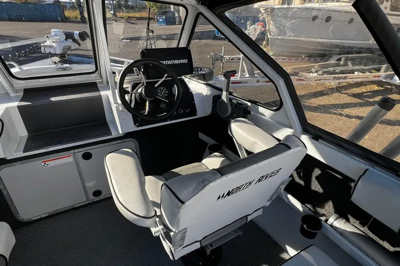 Slide: The Image of Interior of a 2008 North River 18 SEA HAWK boat with steering wheel and seating. - 5