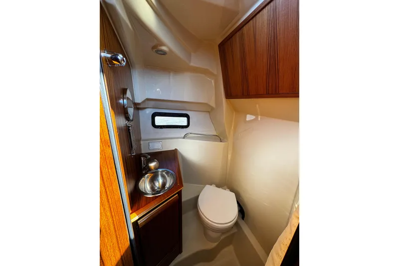 Slide: The Image of 2024 Ranger Tugs R-25 interior with wooden table and seating area. - 5