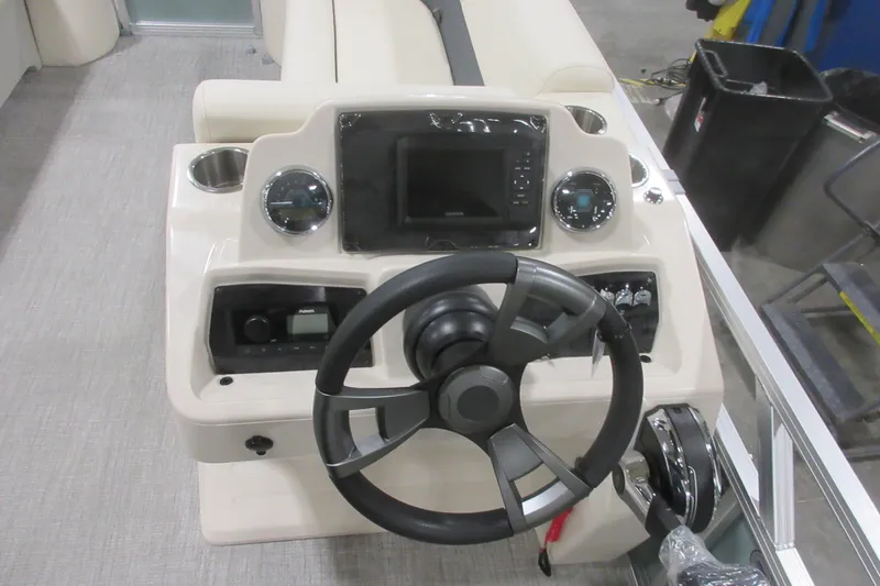 Slide: The Image of 2026 Avalon VLS Quad Lounge boat dashboard with steering wheel and control panel. - 13