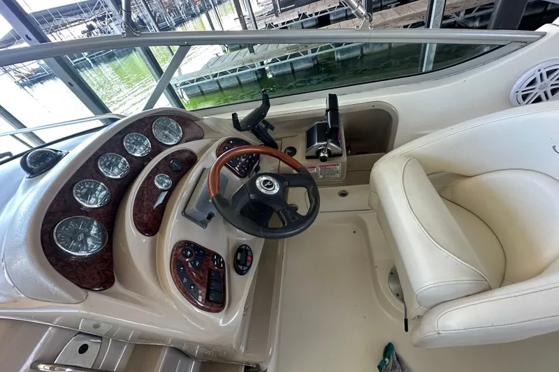 Slide: The Image of 2005 Sea Ray 280 Sundancer boat interior with white cushioned seating. - 10