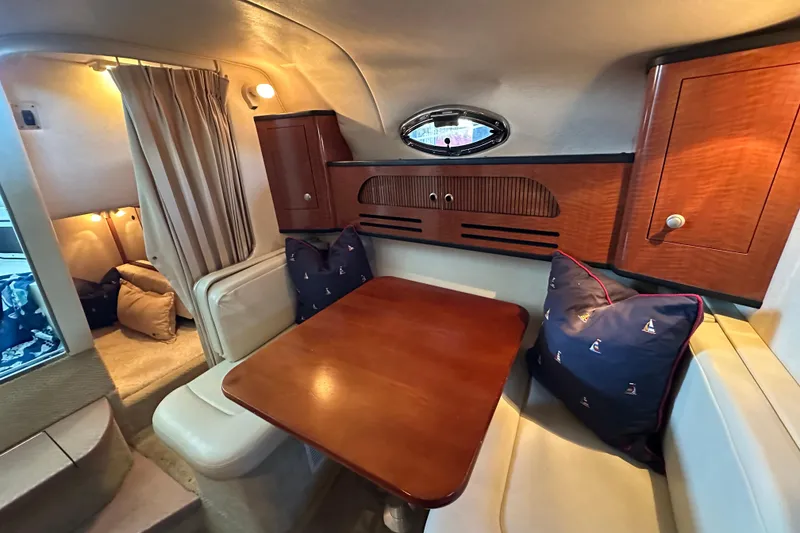 Slide: The Image of Interior of 2005 Sea Ray 280 Sundancer with carpeted flooring and compact seating area. - 16