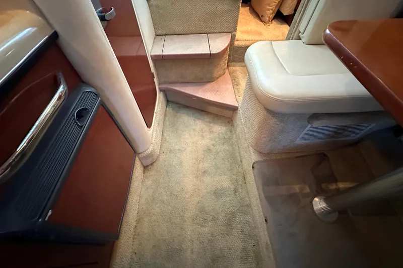 Slide: The Image of Interior of 2005 Sea Ray 280 Sundancer with TV, kitchenette, and cozy seating area. - 18