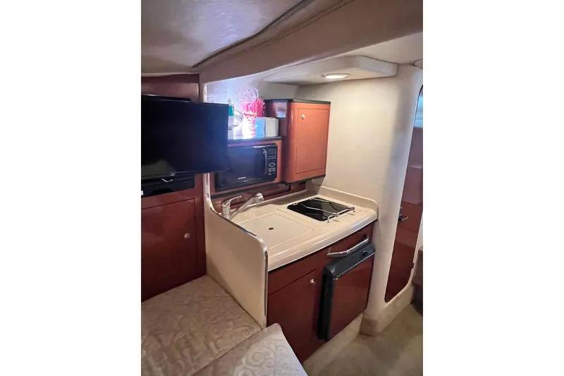 Slide: The Image of Luxurious cabin interior of 2005 Sea Ray 280 Sundancer with plush bedding and pillows. - 19