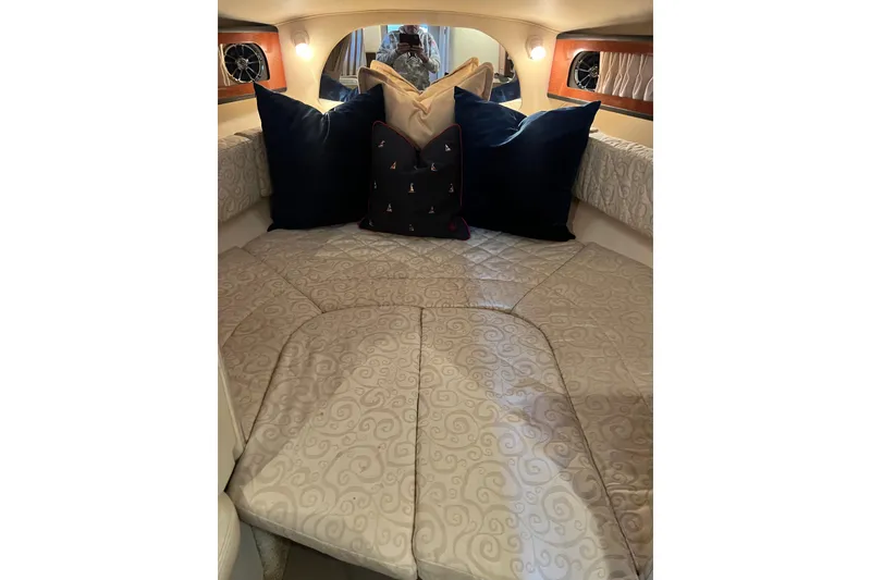 Slide: The Image of Cozy cabin interior of 2005 Sea Ray 280 Sundancer with plush pillows and ambient lighting. - 21