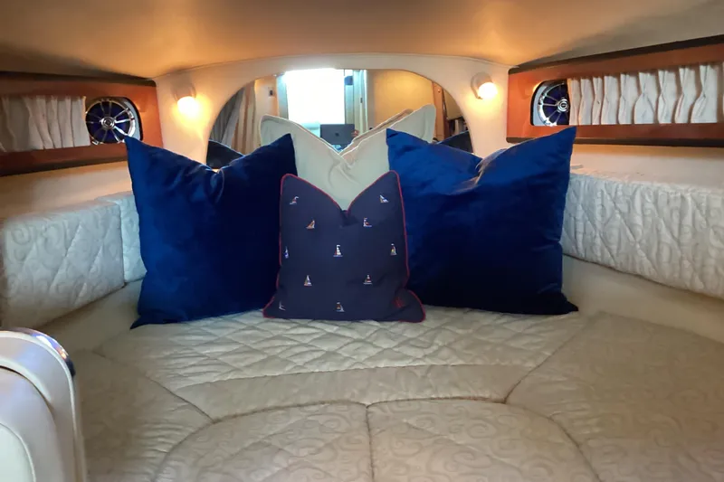 Slide: The Image of 2005 Sea Ray 280 Sundancer docked under a covered marina with scenic water view. - 23