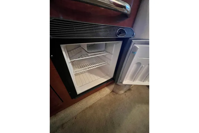 Slide: The Image of Electrical panel inside 2005 Sea Ray 280 Sundancer boat cabin, featuring control switches and stereo system. - 27