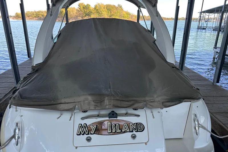 Slide: The Image of 2005 Sea Ray 280 Sundancer boat interior with white seating and storage compartment. - 4
