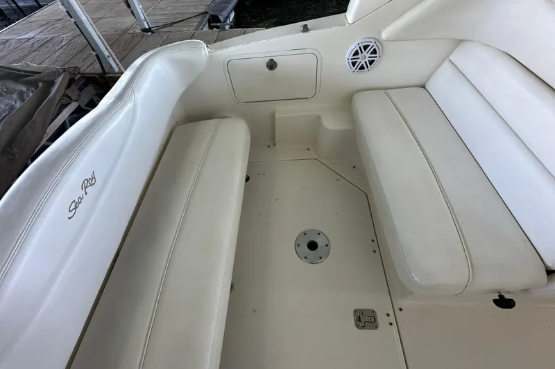 Slide: The Image of 2005 Sea Ray 280 Sundancer boat interior with white seating and storage compartments. - 6