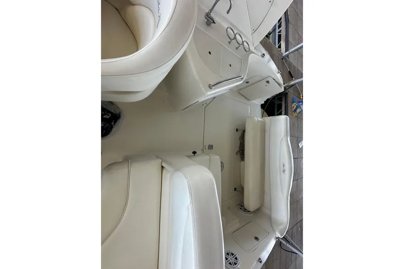 Slide: The Image of 2005 Sea Ray 280 Sundancer helm with gauges, steering wheel, and control panel. - 8