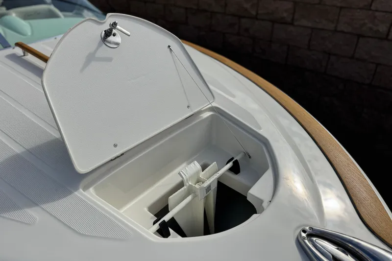 Slide: The Image of 2005 Chris-Craft Speedster boat with open storage compartment, showcasing sleek design and wood accents. - 10