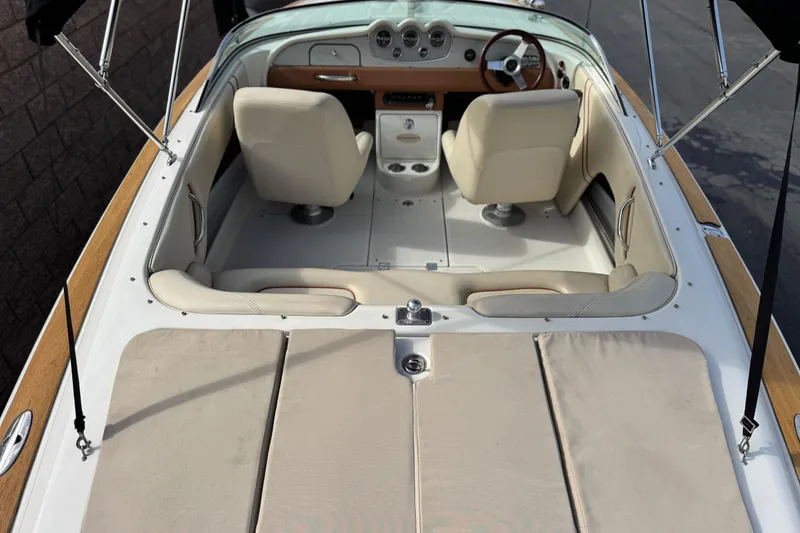 Slide: The Image of 2005 Chris-Craft Speedster boat interior with beige seats and wooden accents. - 12