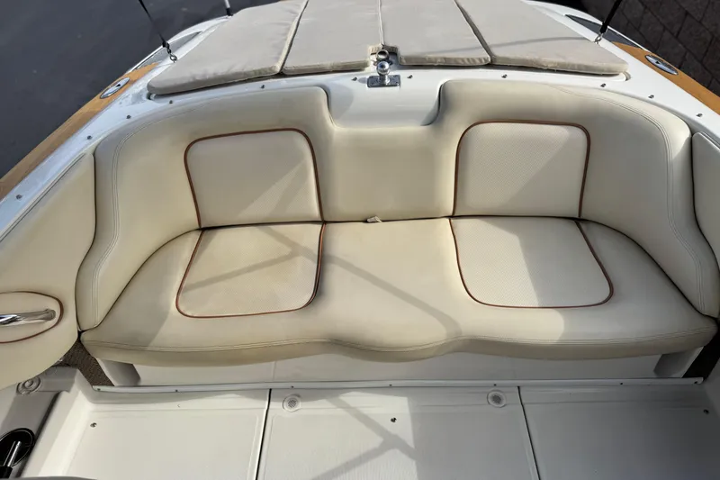Slide: The Image of 2005 Chris-Craft Speedster boat interior with beige cushioned seating. - 14