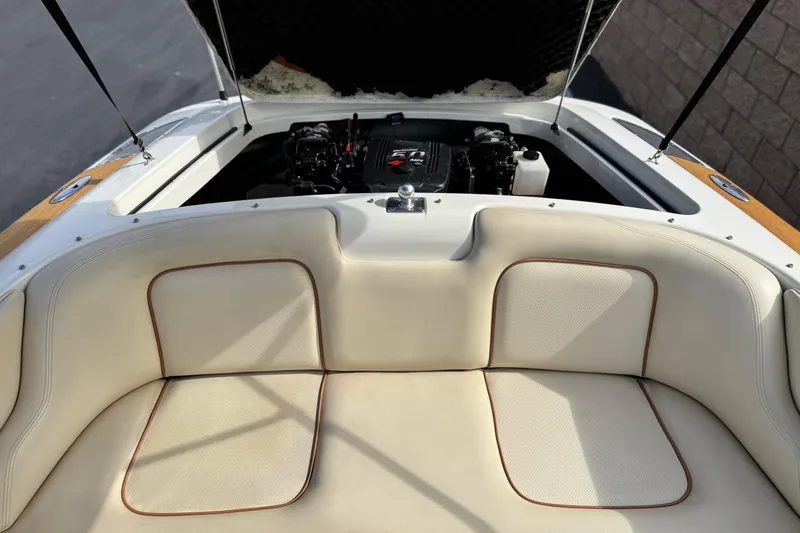 Slide: The Image of 2005 Chris-Craft Speedster boat interior with open engine compartment and beige seating. - 16