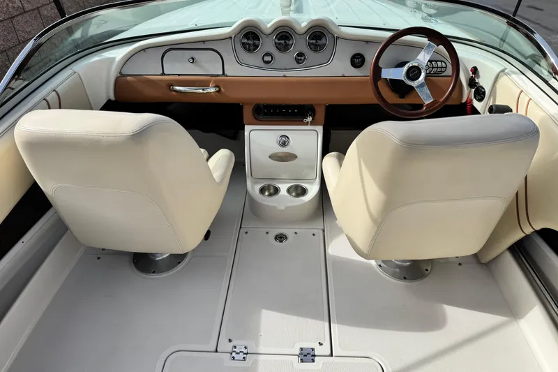 Slide: The Image of 2005 Chris-Craft Speedster interior with beige seats and classic dashboard design. - 18