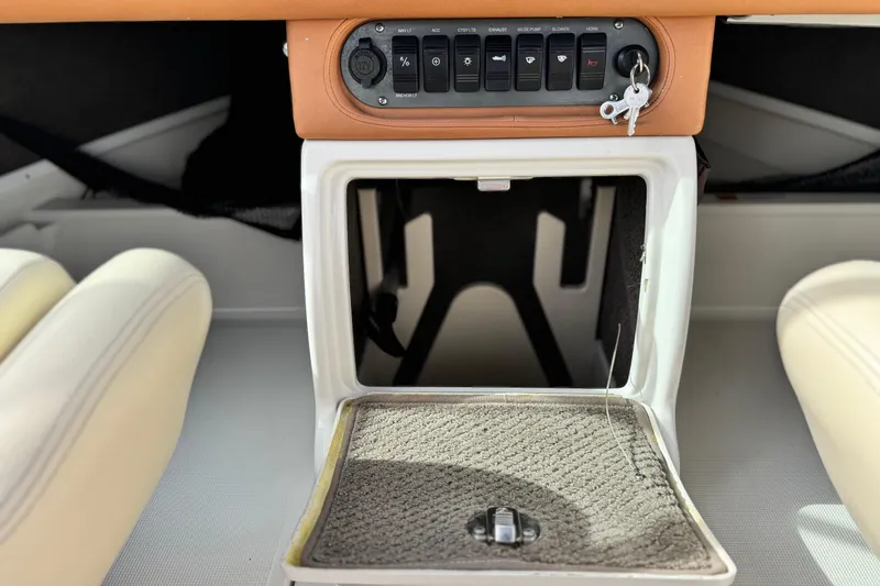 Slide: The Image of 2005 Chris-Craft Speedster dashboard with control panel and storage compartment. - 21