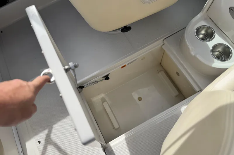 Slide: The Image of 2005 Chris-Craft Speedster storage compartment with cup holders and open hatch. - 22