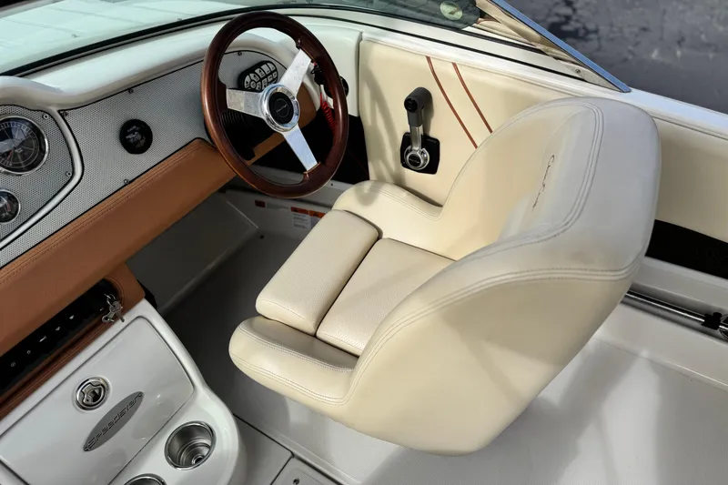 Slide: The Image of 2005 Chris-Craft Speedster interior with beige leather seat and wooden steering wheel. - 23