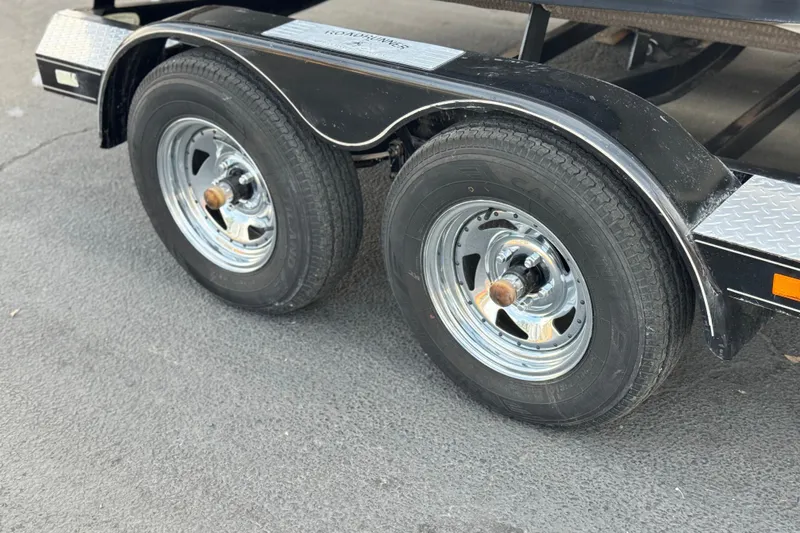 Slide: The Image of Trailer wheels for 2005 Chris-Craft Speedster, featuring chrome rims and black fenders. - 26