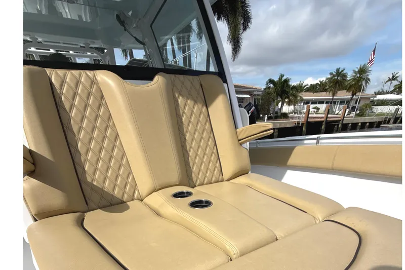 Slide: The Image of 2023 Sportsman Open 352 Center Console boat with tan quilted seating and cup holders. - 15