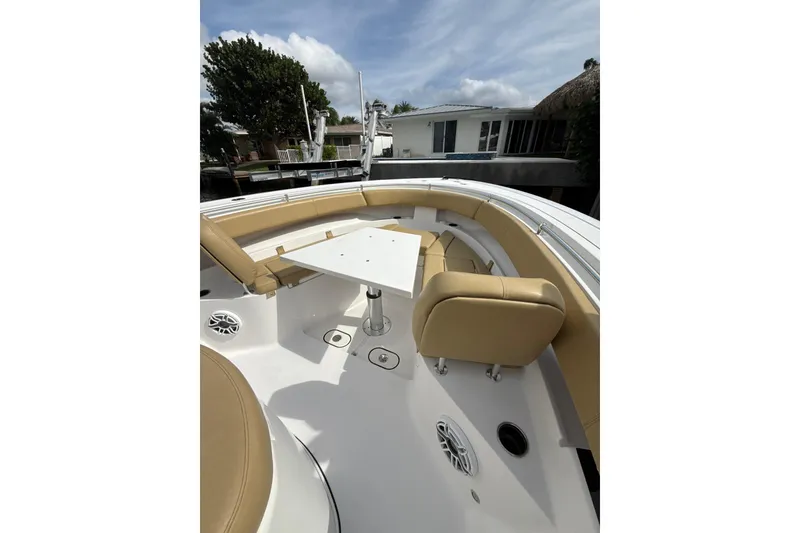 Slide: The Image of 2023 Sportsman Open 352 Center Console boat with tan seating and white table. - 17