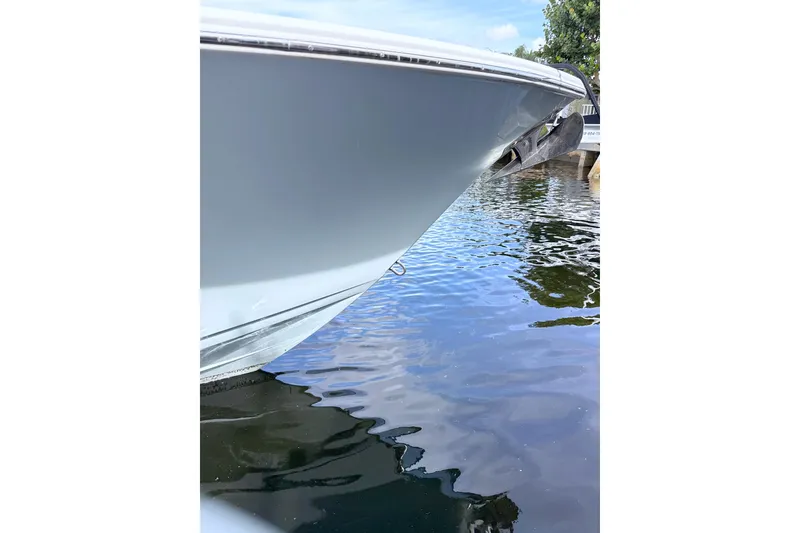 Slide: The Image of 2023 Sportsman Open 352 Center Console boat bow on calm water. - 21