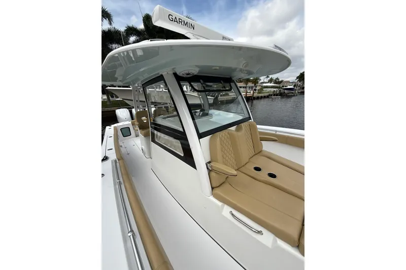 Slide: The Image of 2023 Sportsman Open 352 Center Console boat with tan seating and Garmin equipment. - 22
