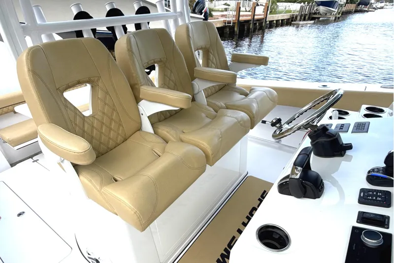 Slide: The Image of 2023 Sportsman Open 352 Center Console with tan leather seats and modern helm controls. - 23
