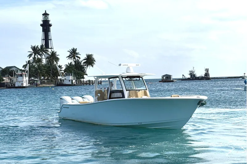 Slide: The Image of 2023 Sportsman Open 352 Center Console boat near lighthouse and palm trees. - 3