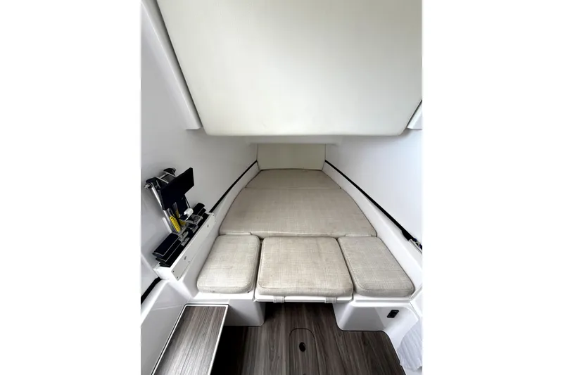 Slide: The Image of 2023 Sportsman Open 352 Center Console cabin interior with cushioned seating and storage. - 36