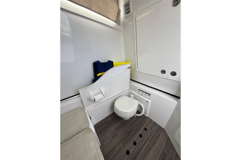 Slide: The Image of 2023 Sportsman Open 352 Center Console interior with toilet and seating area. - 40