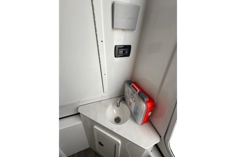 Slide: The Image of 2023 Sportsman Open 352 Center Console interior with sink and first aid kit. - 41