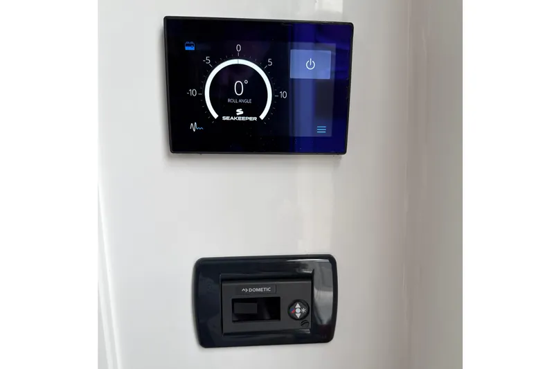 Slide: The Image of 2023 Sportsman Open 352 Center Console control panel with Seakeeper and Dometic displays. - 42