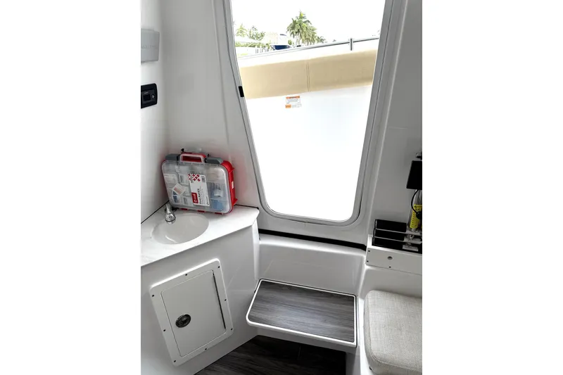 Slide: The Image of 2023 Sportsman Open 352 Center Console interior with sink and first aid kit. - 44
