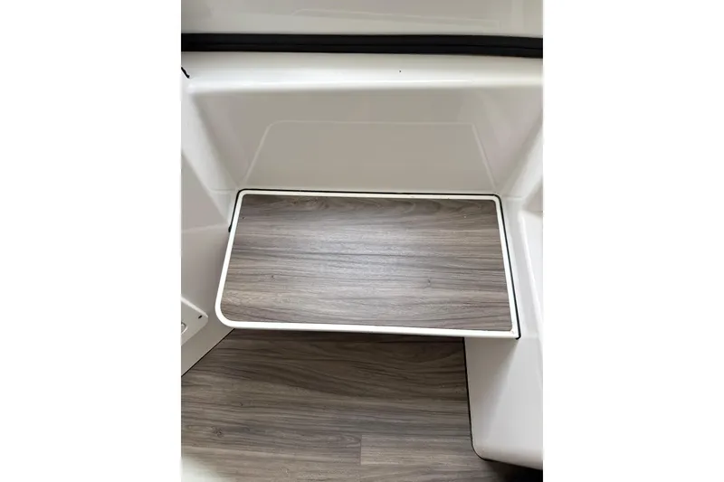 Slide: The Image of 2023 Sportsman Open 352 Center Console interior with wood-textured step detail. - 45