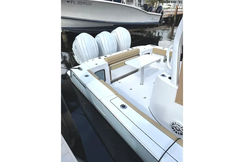 Slide: The Image of 2023 Sportsman Open 352 Center Console boat docked, featuring triple engines and spacious seating. - 47