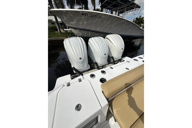 Slide: The Image of 2023 Sportsman Open 352 Center Console with triple outboard engines docked. - 50