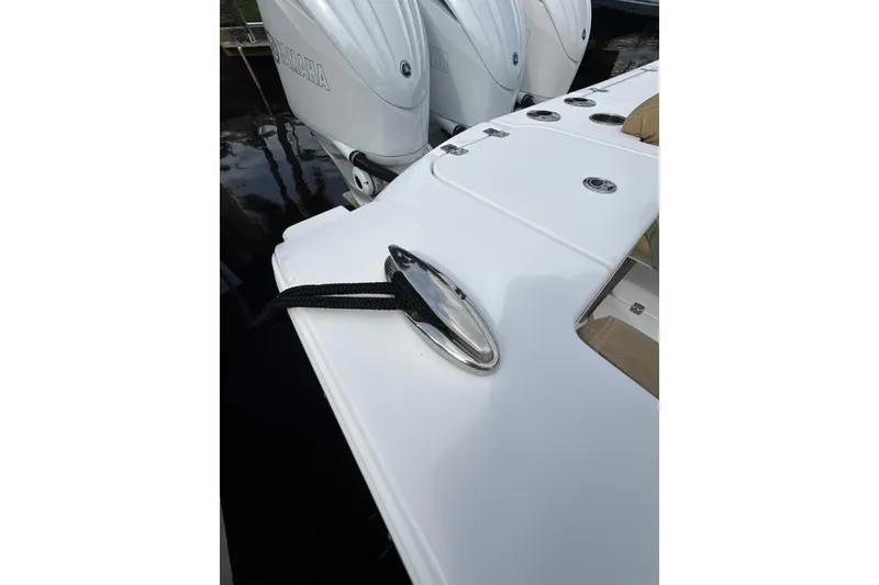Slide: The Image of 2023 Sportsman Open 352 Center Console boat with Yamaha engines and cleat detail. - 53