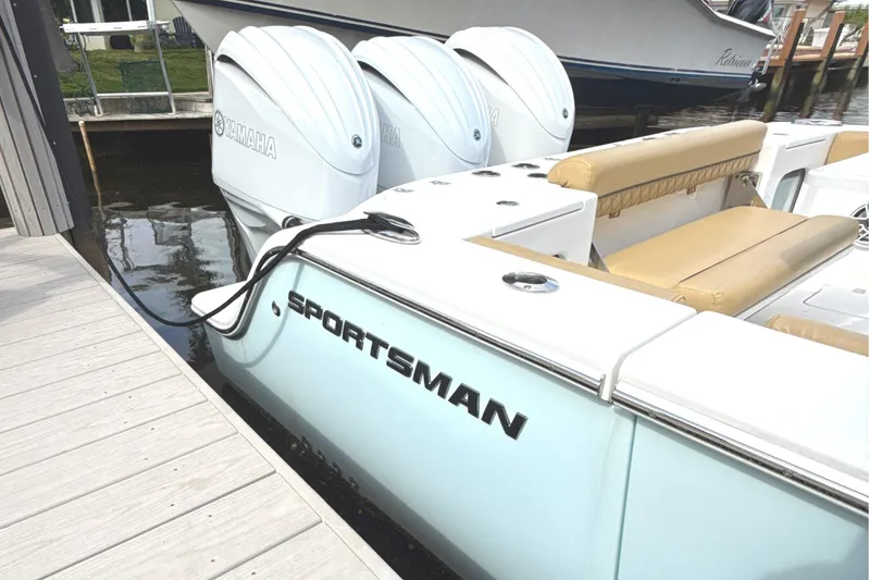 Slide: The Image of 2023 Sportsman Open 352 Center Console docked, featuring Yamaha engines and tan seating. - 6