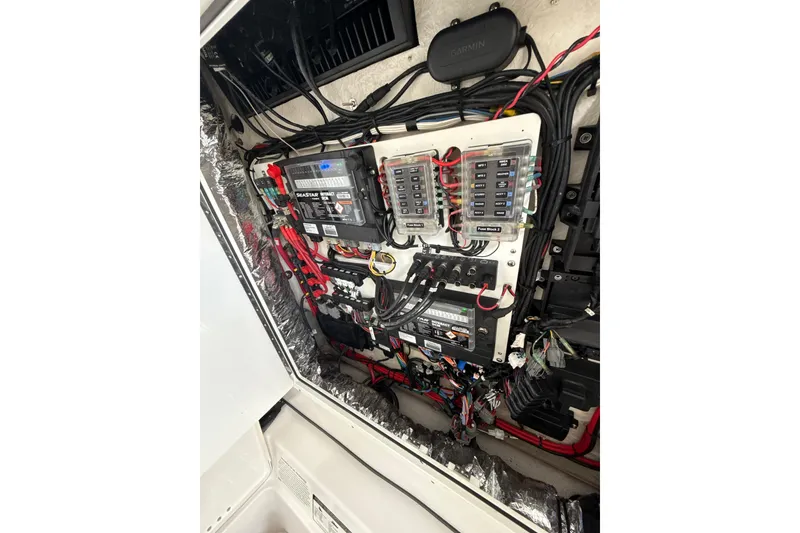 Slide: The Image of Electrical panel of 2023 Sportsman Open 352 Center Console boat, showcasing wiring and components. - 60