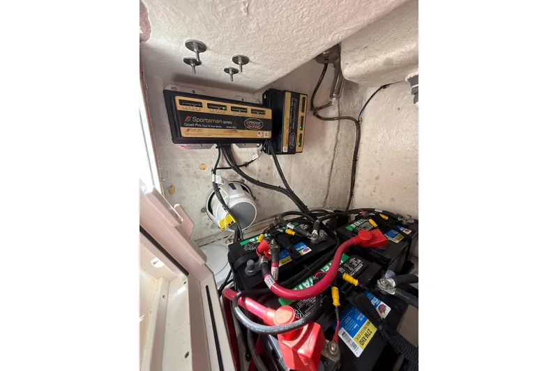 Slide: The Image of 2023 Sportsman Open 352 Center Console battery compartment with charger and wiring. - 62