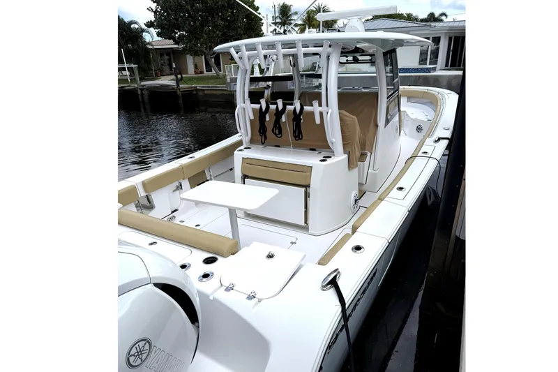 Slide: The Image of 2023 Sportsman Open 352 Center Console boat docked, featuring spacious seating and modern design. - 65