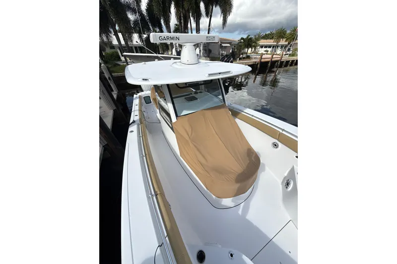 Slide: The Image of 2023 Sportsman Open 352 Center Console boat docked by palm trees. - 66