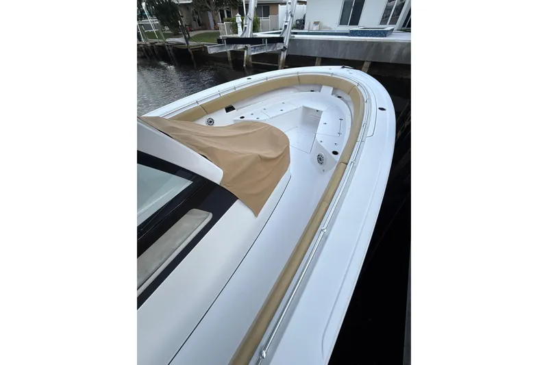 Slide: The Image of 2023 Sportsman Open 352 Center Console boat docked, featuring sleek design and spacious deck. - 67