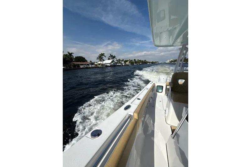 Slide: The Image of 2023 Sportsman Open 352 Center Console cruising on a sunny day, leaving a wake. - 73