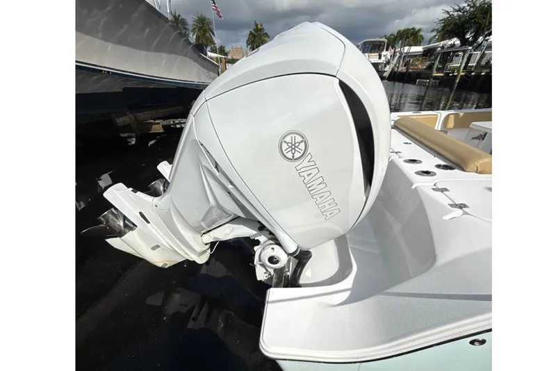 Slide: The Image of 2023 Sportsman Open 352 Center Console with Yamaha outboard motor, docked by the water. - 8