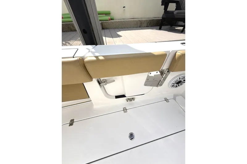 Slide: The Image of 2023 Sportsman Open 352 Center Console boat interior with tan seating and speaker. - 9