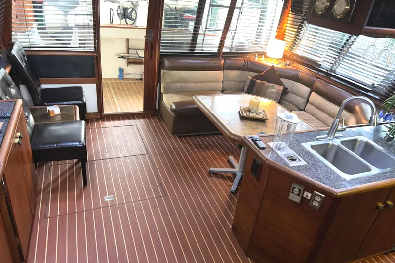 Slide: The Image of Luxurious interior of 1989 Bayliner 4588 Pilothouse with seating, table, and kitchenette. - 10